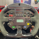 Sèbastian Bourdais' Steering Wheel in his 2006 championship-winning Newman/Haas Racing car. Water button reads "eau" in French.